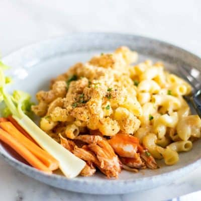 A sideview of a plate of buffalo chicken mac and cheese.