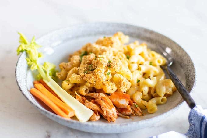 A sideview of a plate of buffalo chicken mac and cheese.