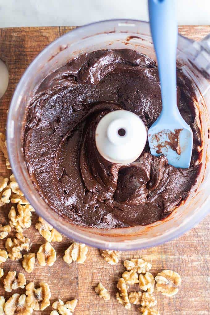 Thick brownie batter in a food processor bowl.