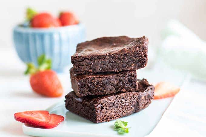 A stack of 3 gluten free vegan brownies without nuts.