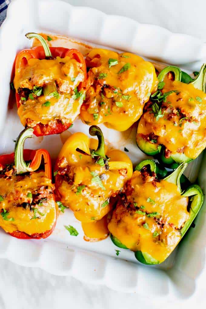 A casserole dish with baked stuffed bell peppers.