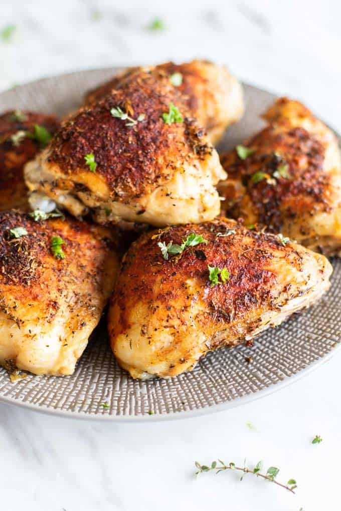 A plate of crispy baked chicken thighs.