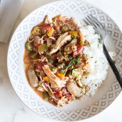 Easy crockpot gumbo recipe shown served over rice on a plate.