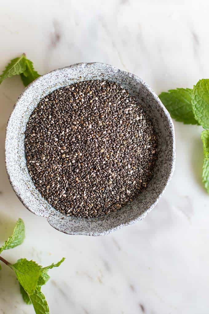 A container of chia seeds showing the size and texture of this ingredient.