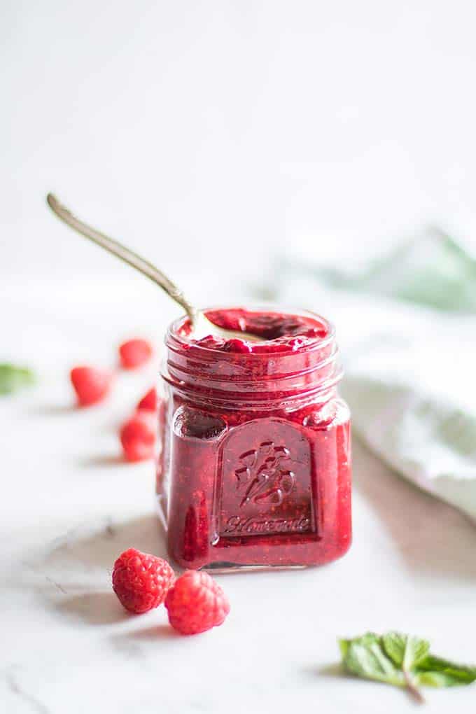A jar of homemade raspberry jam with chia seeds.