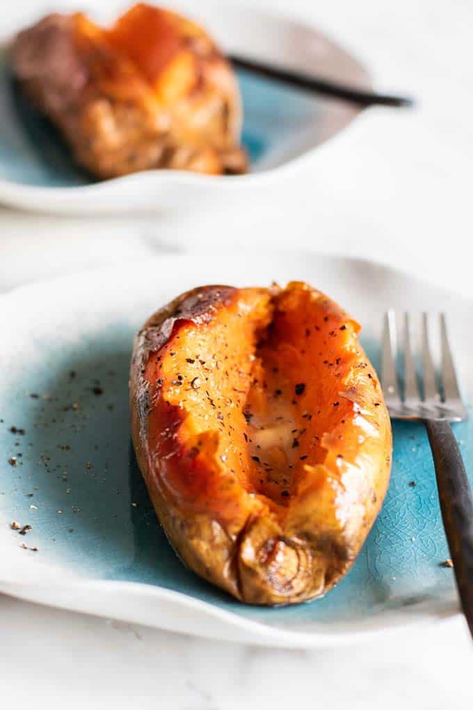 Two baked sweet potatoes ready to be filled.