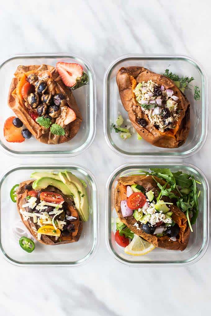 Four sweet potatoes in meal prep containers.