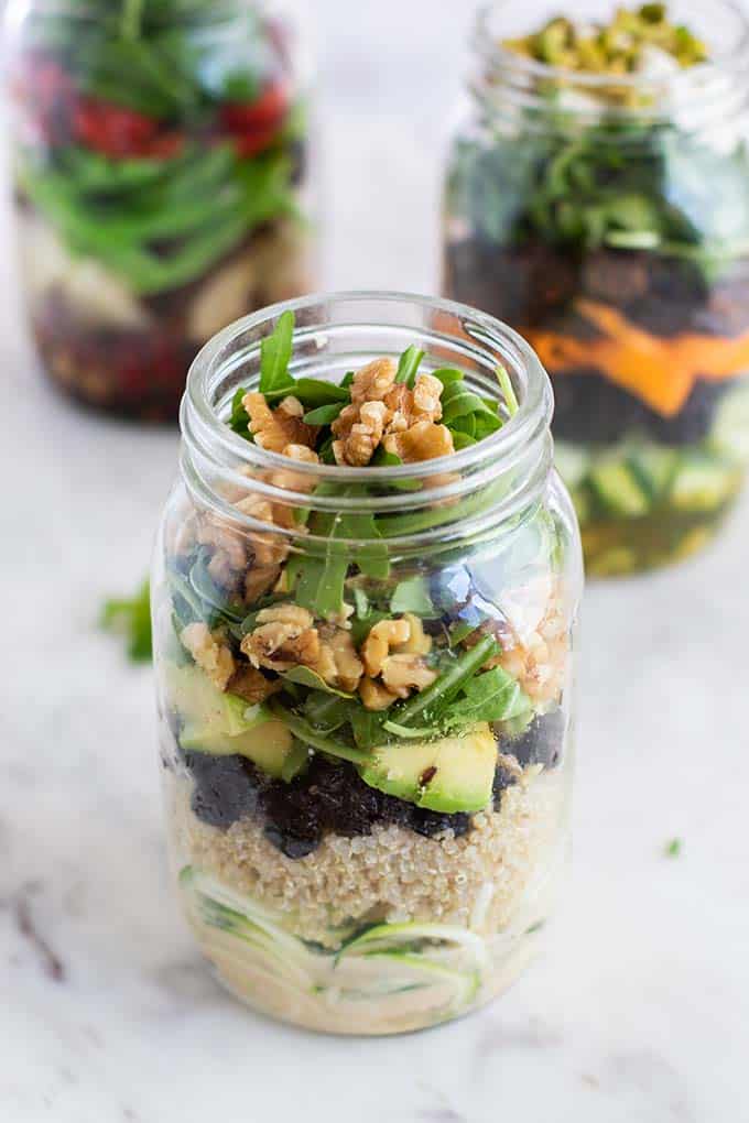 A cherry quinoa and zoodle salad packed in a mason jar.