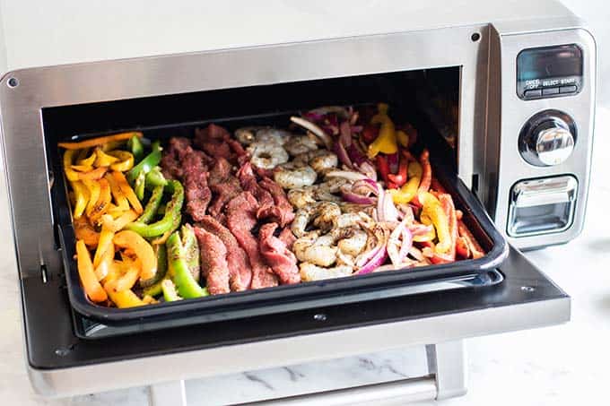 The Sharp Superheated Steam Countertop Oven with a sheet pan of fajita ingredients ready to be baked.