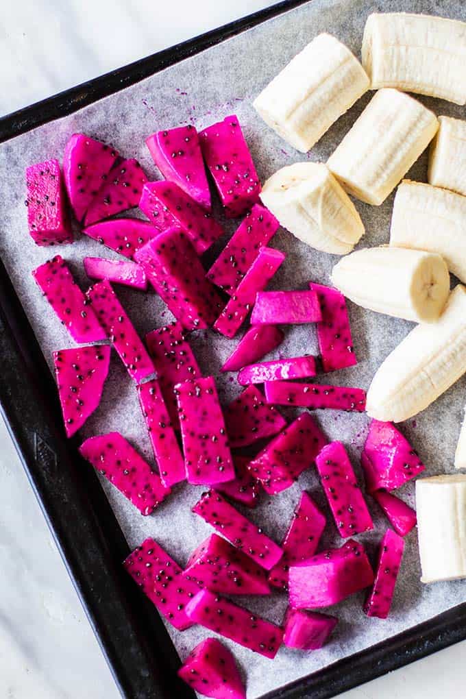 A close up of red dragon fruit chopped into cubes ready to be frozen.