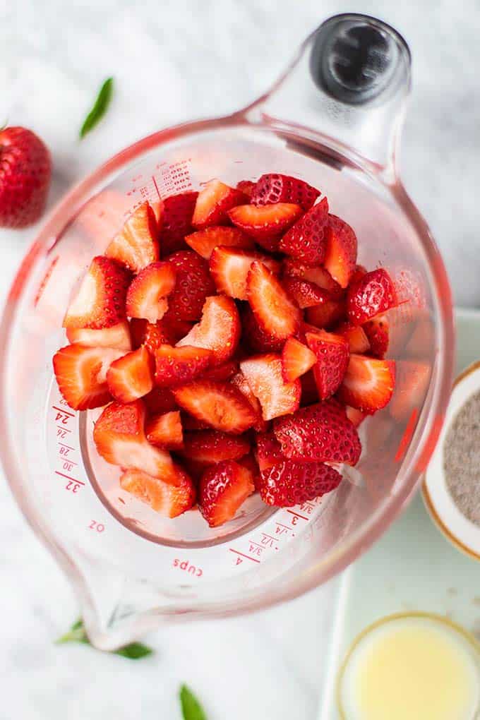 Strawberries chopped in a measuring cup.