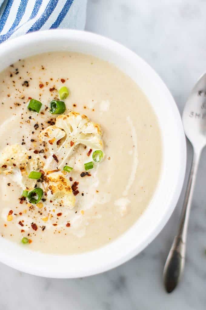 A close up of a bowl of creamy roasted cauliflower soup.