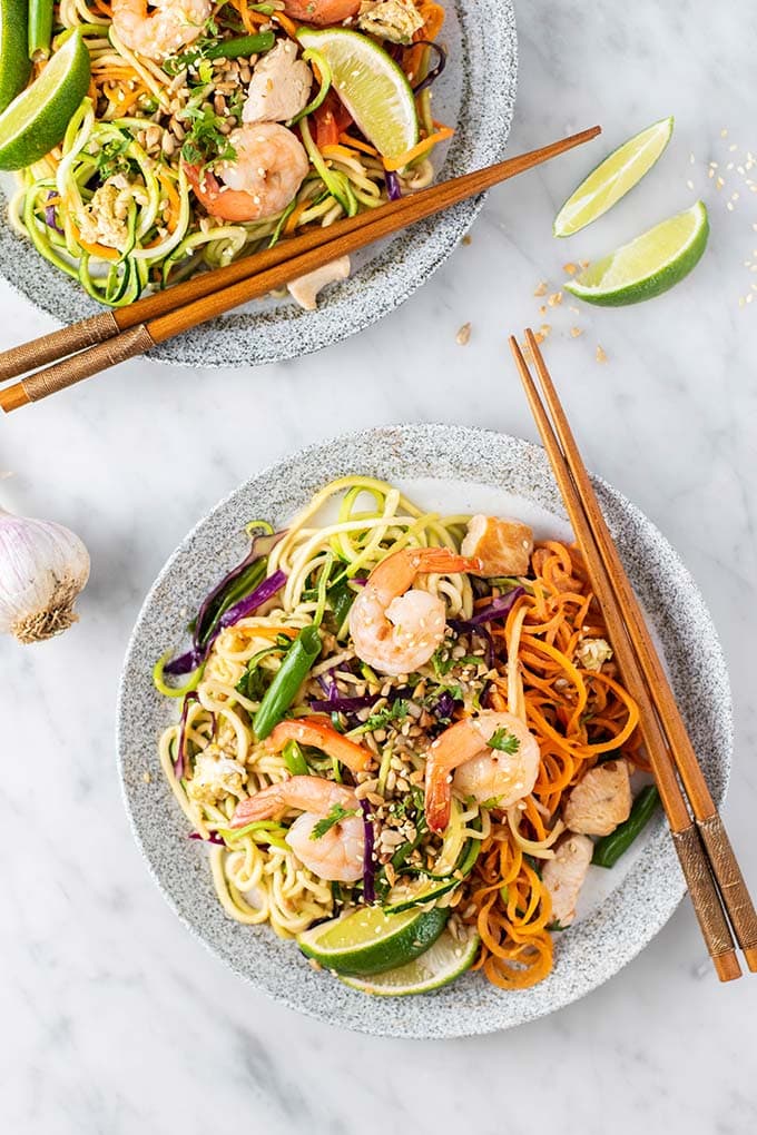 Two plates shown with paleo pad thai and chopsticks.