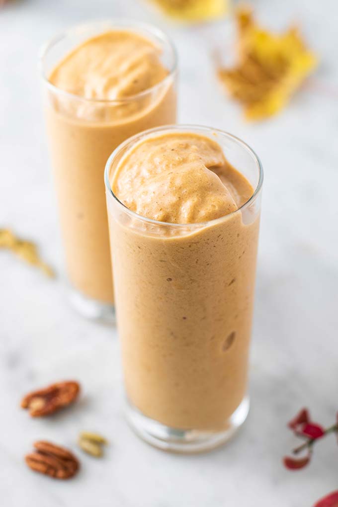 Two thick pumpkin spice latte smoothies in clear glasses.