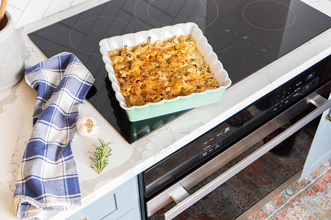 A baked dish of cauliflower cheese sitting on top of the Sharp European Convection Oven.