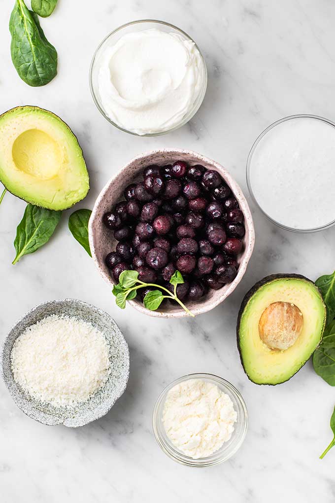 The ingredients for a blueberry smoothie prepared and ready to be blended.