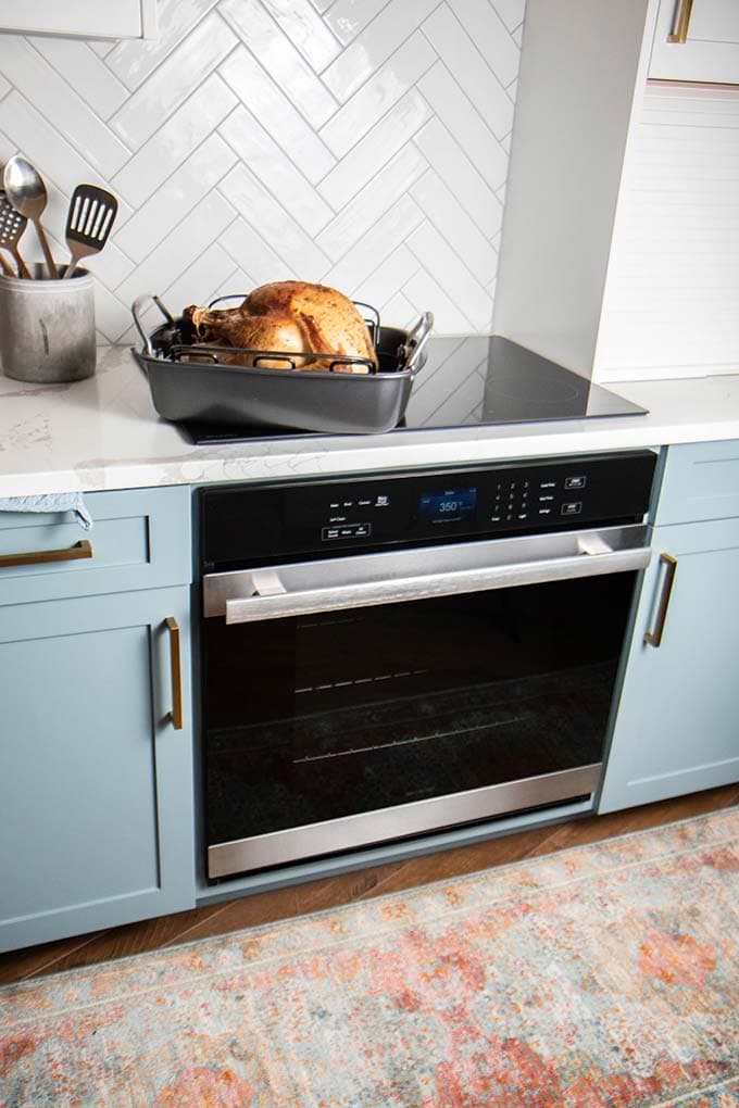 A turkey in a roasting pan sitting on top of the Sharp European Convection Oven.