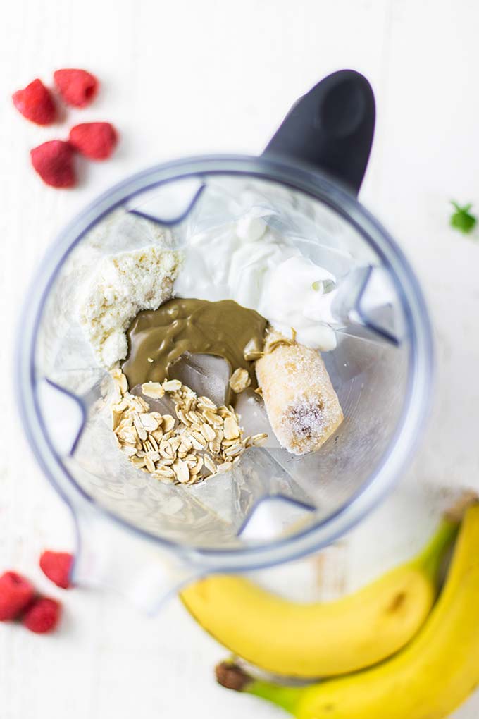 Ingredients for a banana oatmeal smoothie shown in a blender.