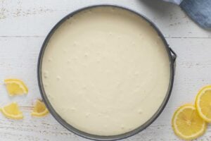 Pour the cheesecake batter into the spring form pan on top of the crust.