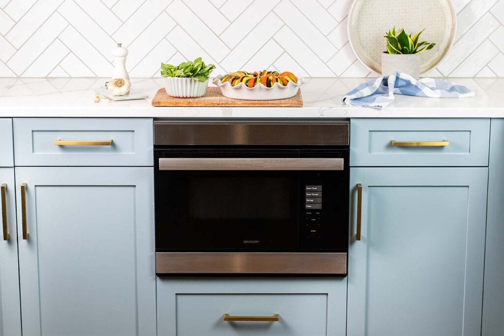 The Sharp Superheated Steam Wall Oven shown with a finished vegetable dish.