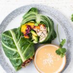 A rainbow of veggies shown in an Asian Chicken Collard Wrap served with a creamy dipping sauce.