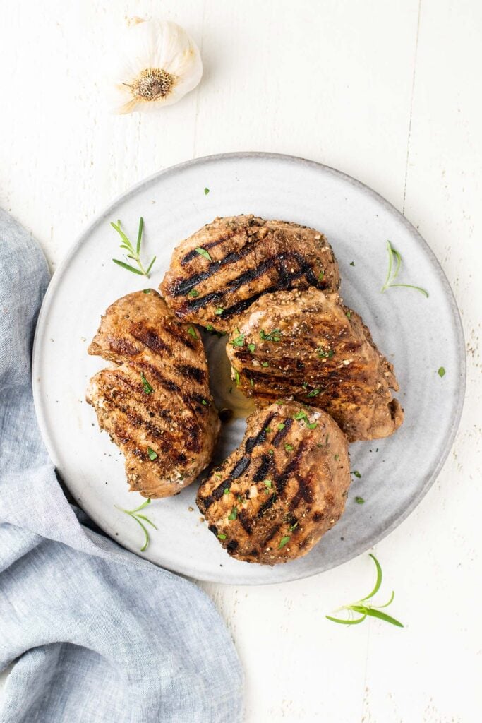 A top down look at 4 grilled pork chops marinated in a balsamic dijon mixture.