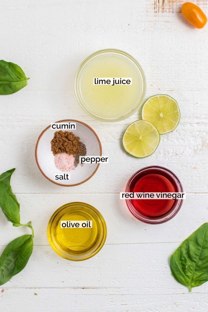 The ingredients for the dressing on this salad shown in containers and labeled.