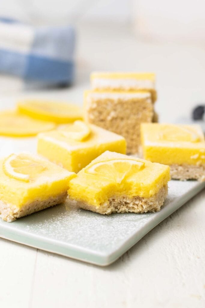 Leon bars shown stacked on a blue cutting board with a bite taken out of one.