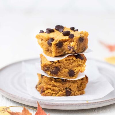 A stack of 3 pumpkin chocolate chip cookie bars.