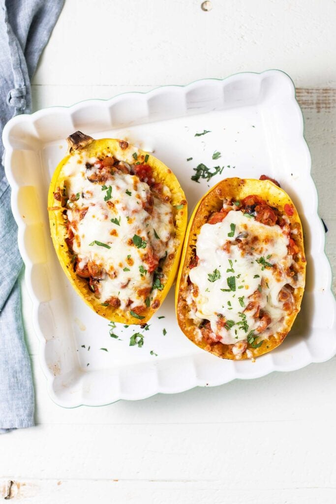 A baking dish with 2 stuffed squash halves.