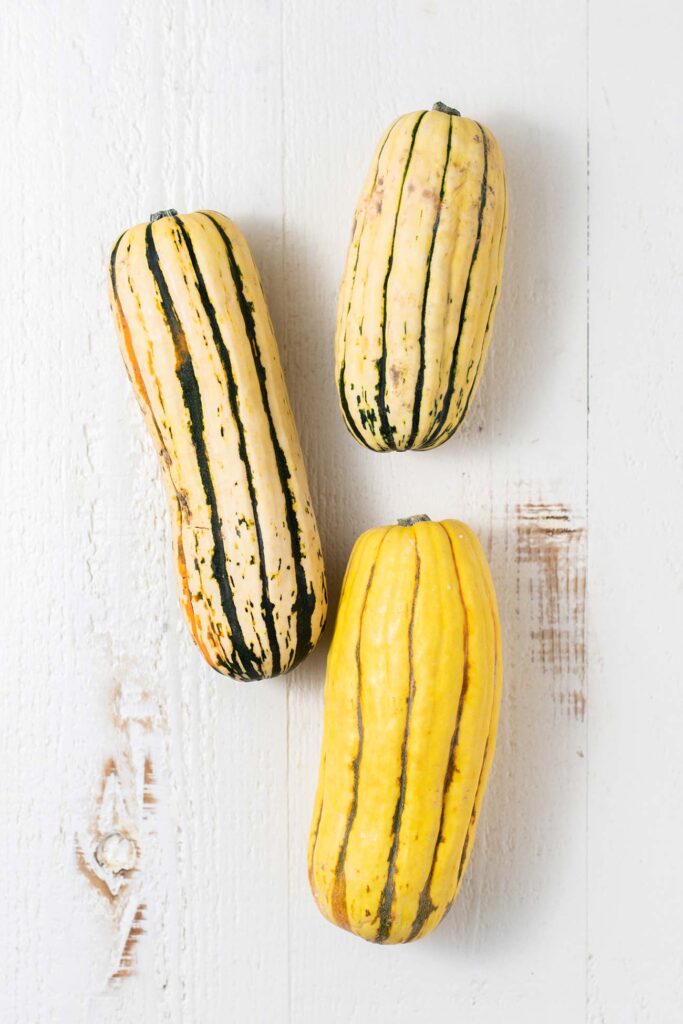 3 delicata squash shown whole.