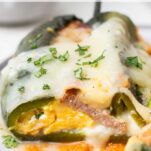 A close up look at a chile relleno stuffed with eggs, cheese, and sausage.