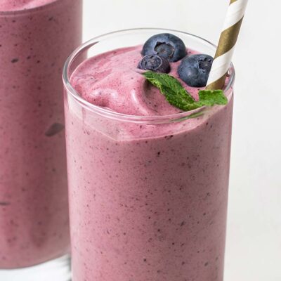 A close up look at an acai smoothie topped with blueberries.