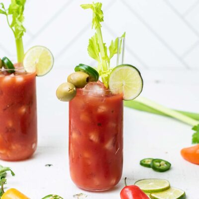 Two cocktails shown with lots of garnishes.