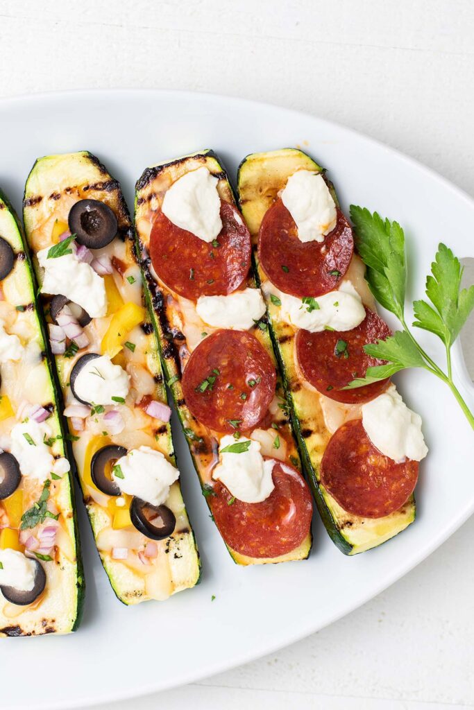 Zucchini pizza boats topped with pepperoni.