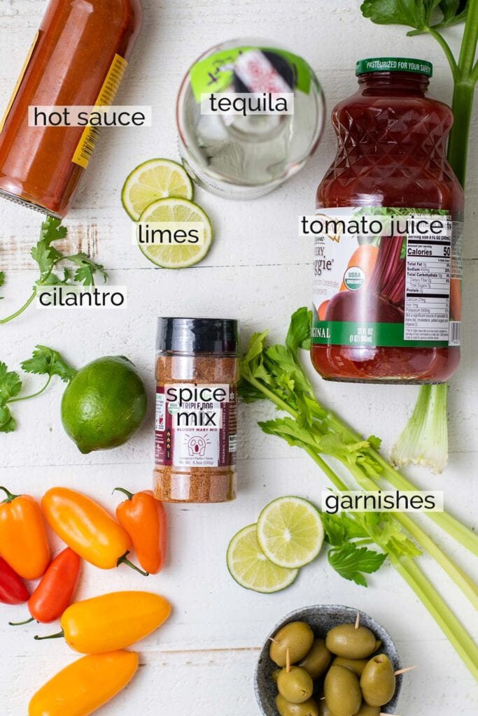 The ingredients needed for a bloody maria cocktail shown with labels.