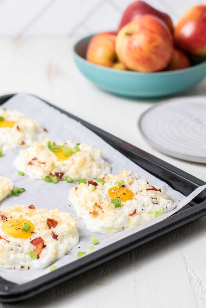 Cloud Eggs shown baked on a tray and garnished with green onions.