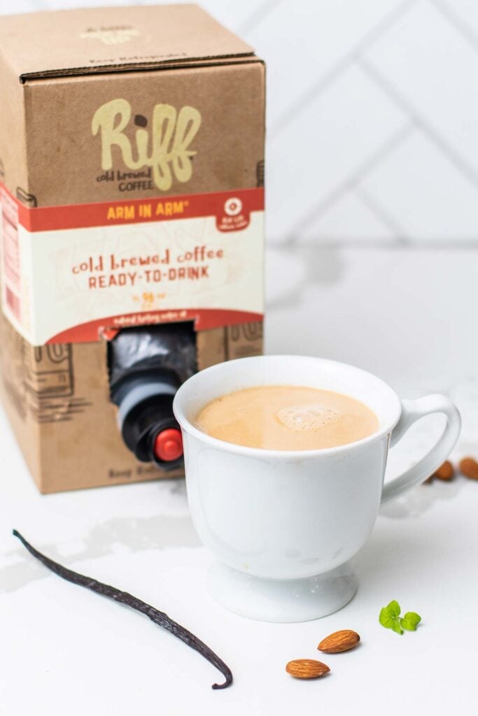 a box of Riff cold brew with a hot almond milk latte sitting in front of it.