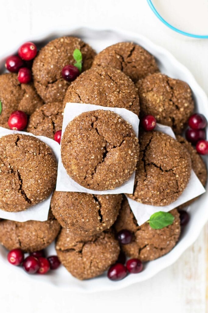A dish filled with chewy ginger sugar cookies.