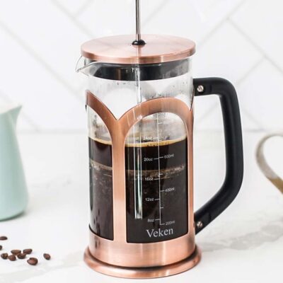 A French press shown steeping coffee.