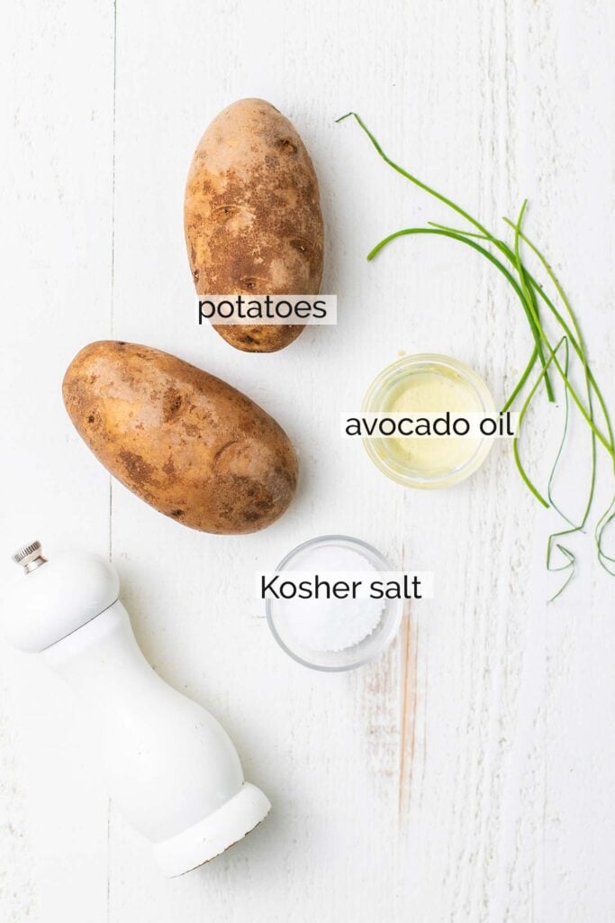 The ingredients needed to prepare potatoes in an air fryer.
