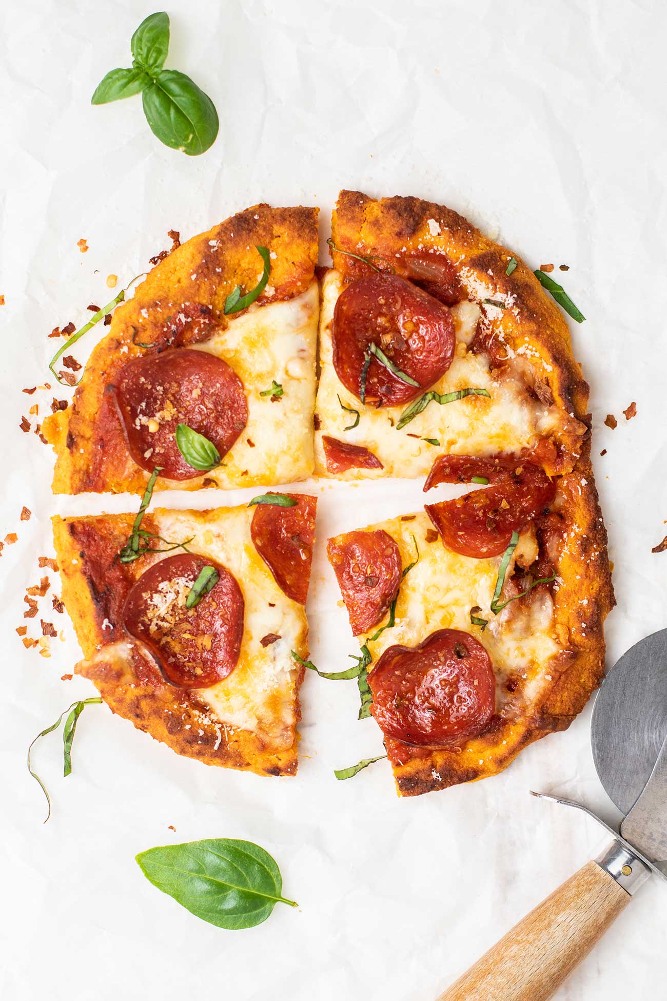 A mini sweet potato pizza crust topped with mozzarella cheese and pepperoni.