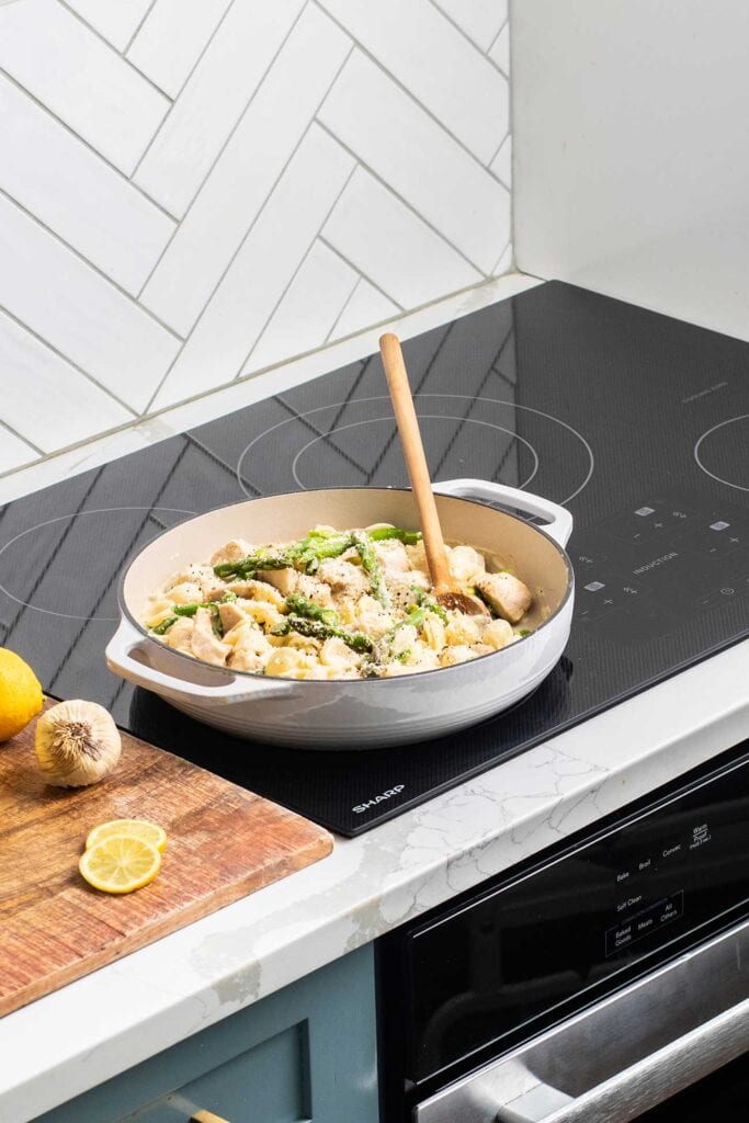 A creamy lemon chicken pasta in a pot on the Sharp Induction Cooktop.