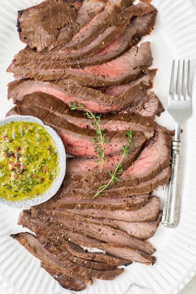 Thinly sliced london broil on a platter.