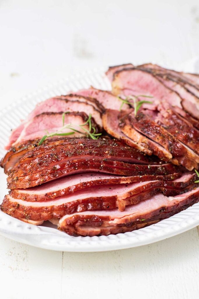 A plate piled high with honey baked ham.