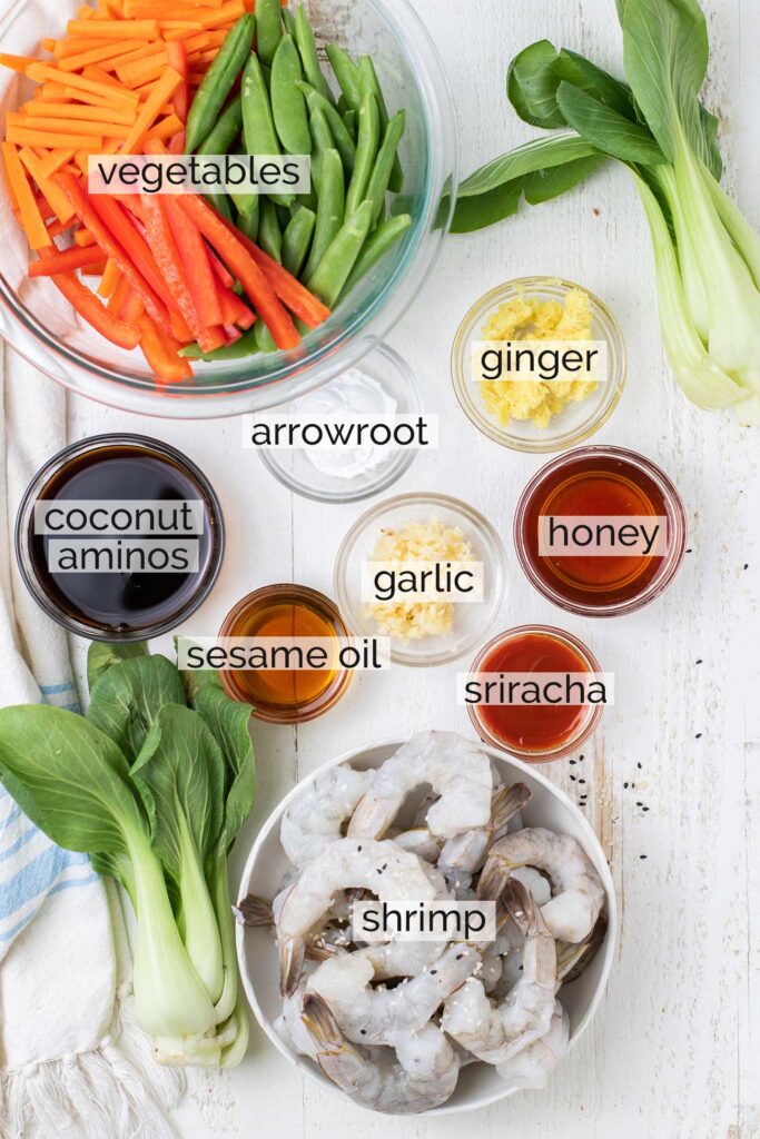 The ingredients needed to make a homemade teriyaki sauce and shrimp stir fry shown with labels.