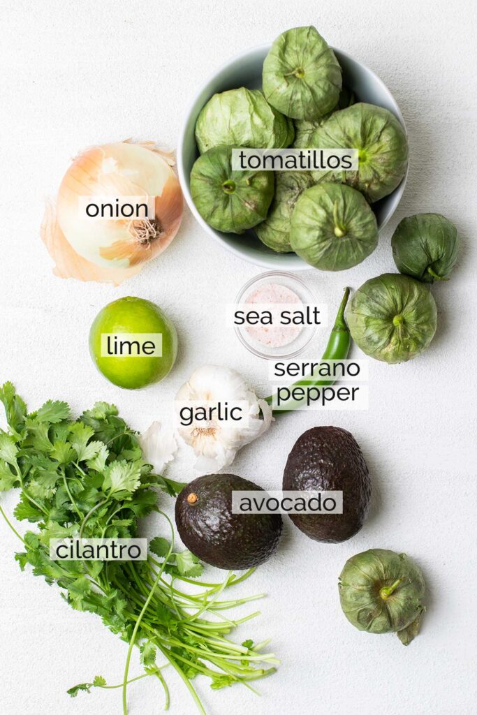 The ingredients needed to make a creamy tomatillo avocado salsa.