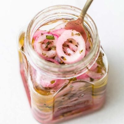 Looking down into a jar of marinated red onions.