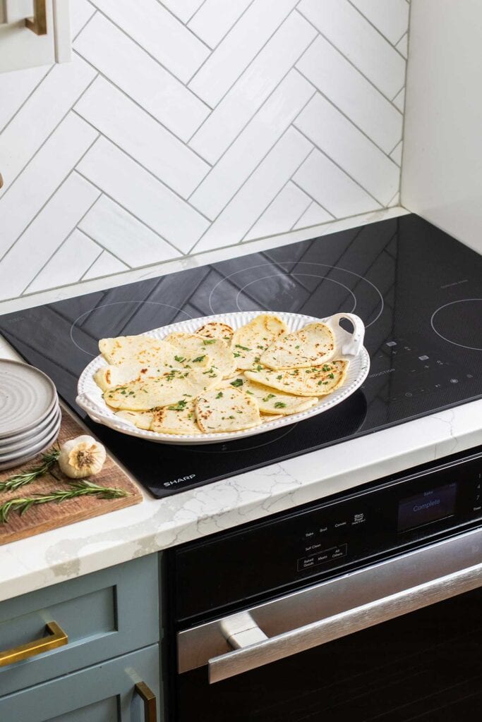 The Sharp Induction Cooktop shown with a platter of gluten free flatbread.