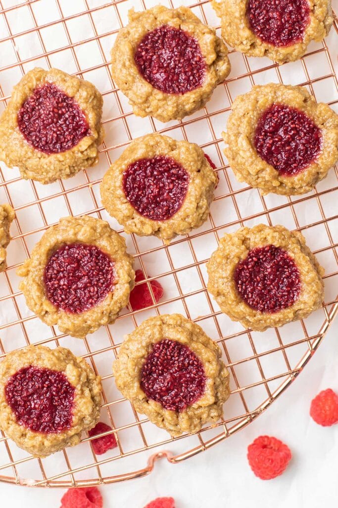 Oatmeal thumbprint cookies shown with a raspberry jam filling.